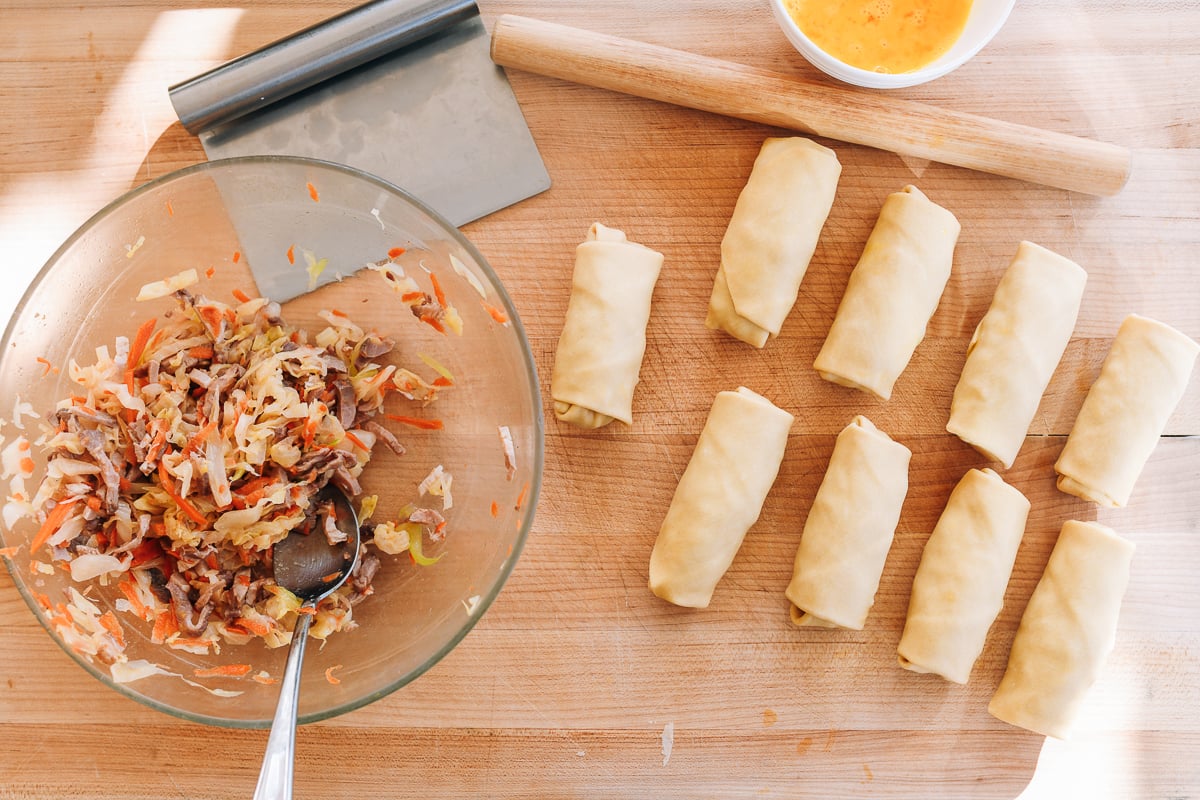 assembled egg rolls on cutting board