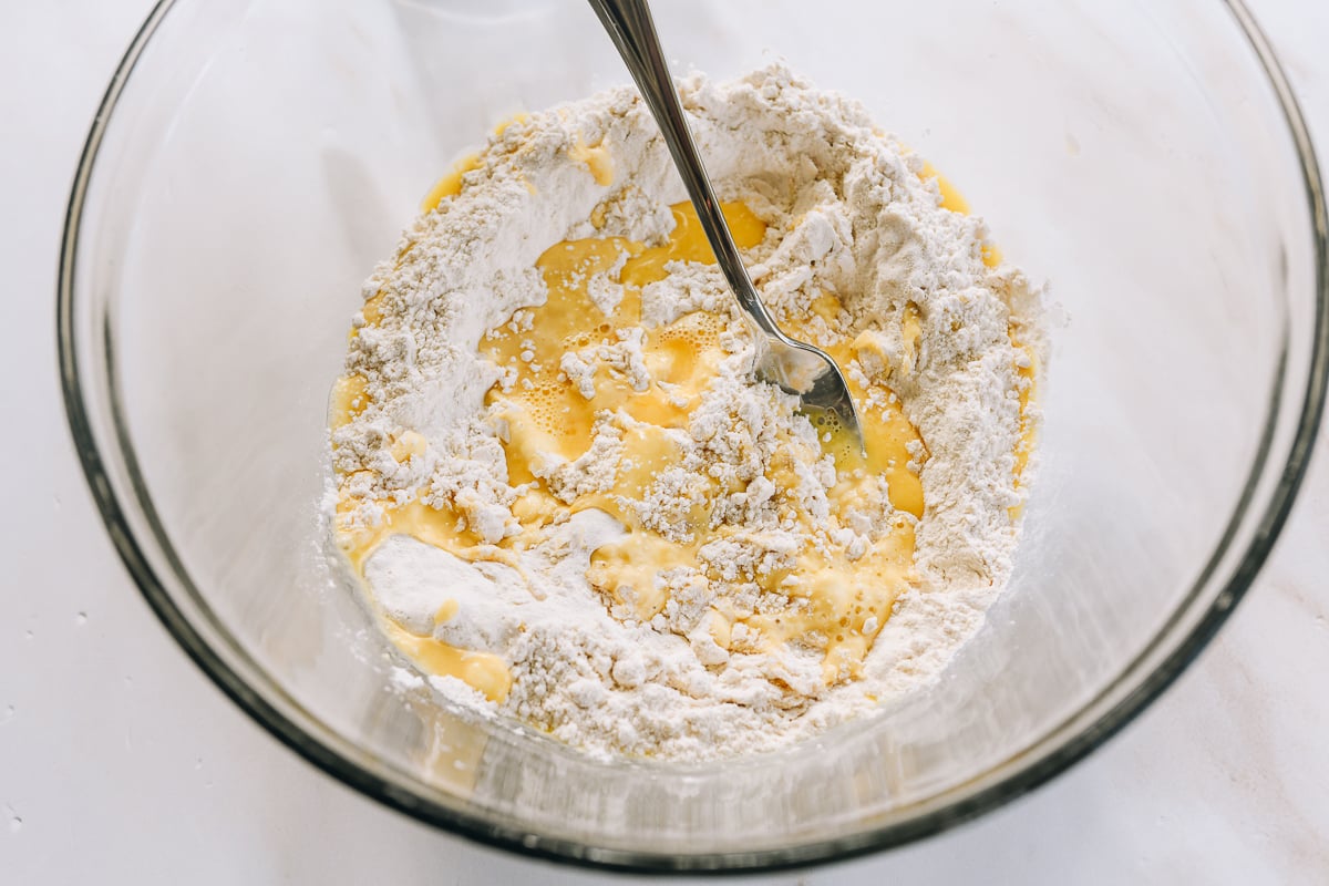 combining flour and salt with egg yolk and water