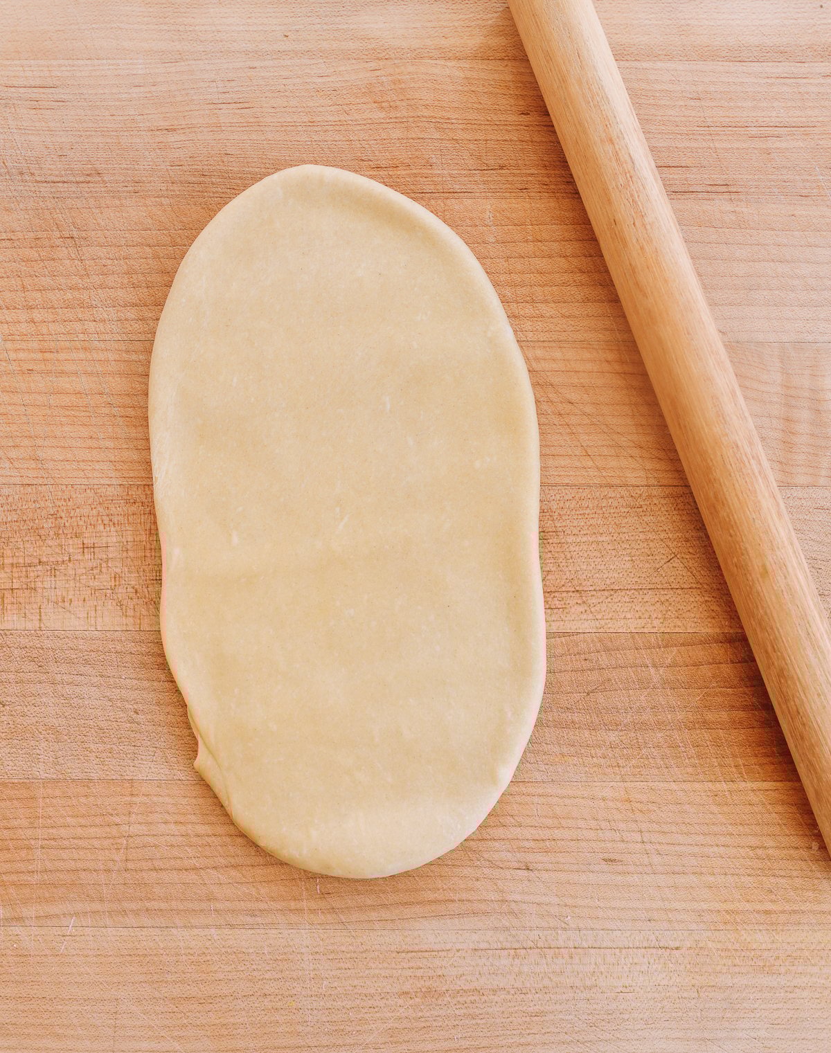 rolling out dough sheet with Chinese rolling pin