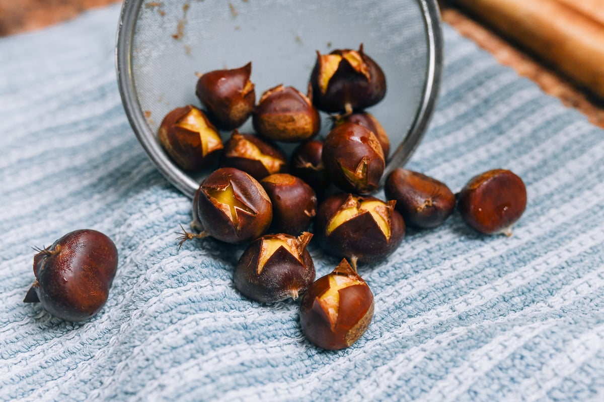 pouring boiled chestnuts onto kitchen towel
