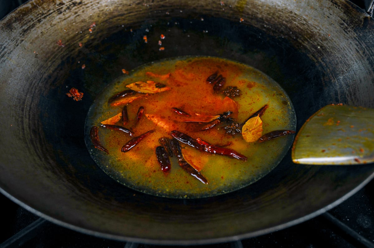 stock added to aromatics in wok