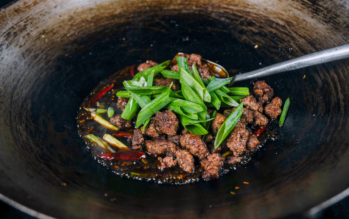 scallion greens added to beef in wok